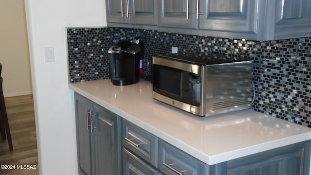 interior space featuring backsplash and hardwood / wood-style floors