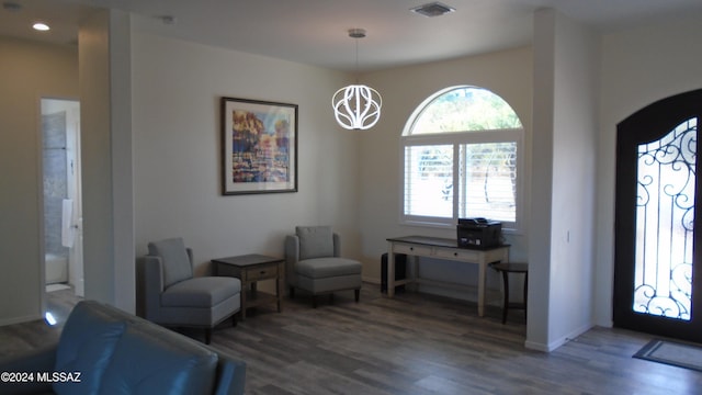 entryway featuring plenty of natural light, dark hardwood / wood-style floors, and an inviting chandelier