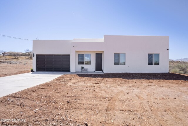 view of front of house featuring a garage and stucco siding