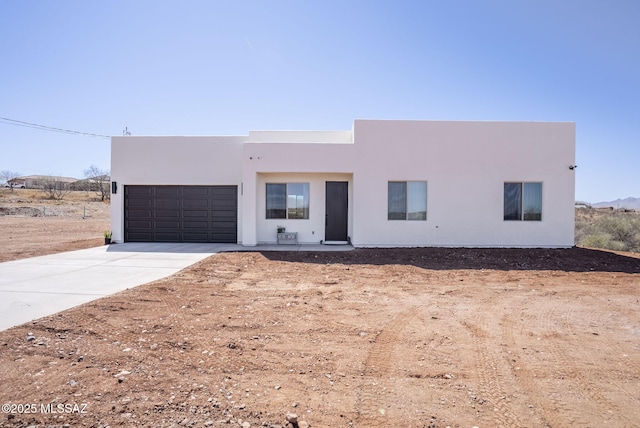 65A Avenida Pastor, Rio Rico, AZ 85648 - pueblo-style home with stucco siding, a garage, and concrete driveway