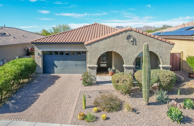 mediterranean / spanish-style house with a garage