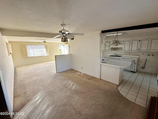 unfurnished living room with ceiling fan, light tile patterned flooring, and sink