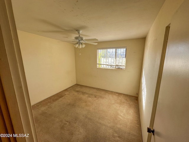 spare room with light carpet and ceiling fan