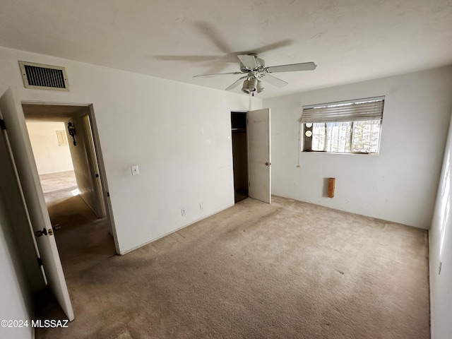 unfurnished bedroom featuring ceiling fan and light colored carpet