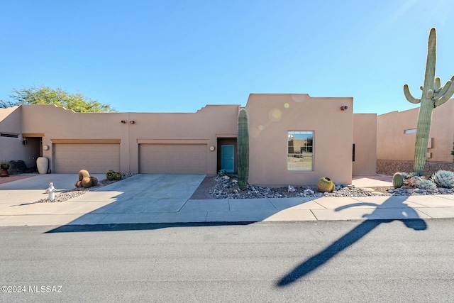 pueblo-style house with a garage