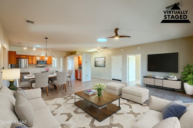 living room with ceiling fan and rail lighting