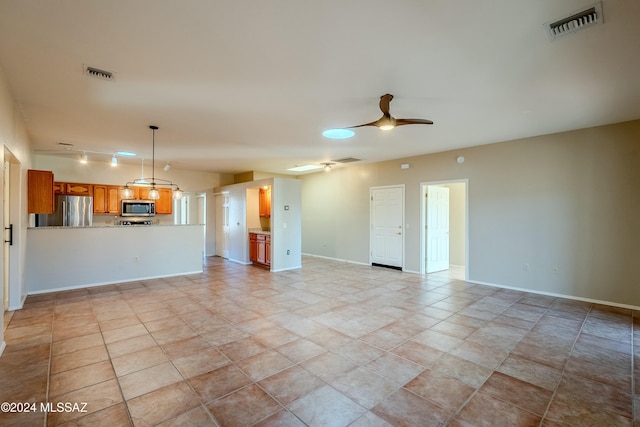 unfurnished living room with ceiling fan and light tile patterned floors