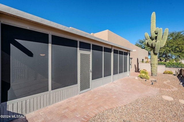 view of patio with a sunroom