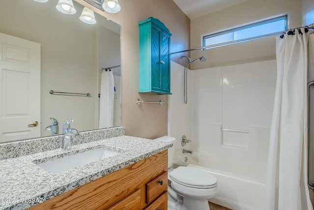 full bathroom with vanity, shower / tub combo, and toilet