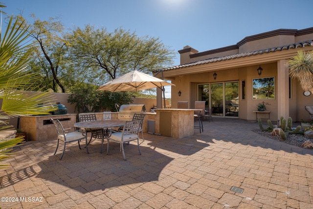 view of patio / terrace featuring area for grilling, an outdoor bar, and grilling area