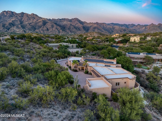 aerial view at dusk featuring a mountain view