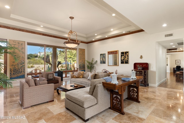 living room featuring a raised ceiling and light hardwood / wood-style flooring