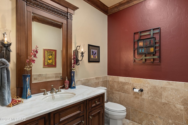 bathroom featuring vanity, toilet, and ornamental molding