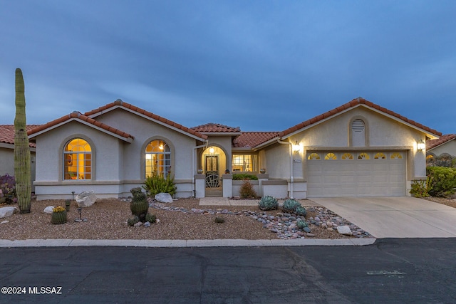 mediterranean / spanish-style home featuring a garage