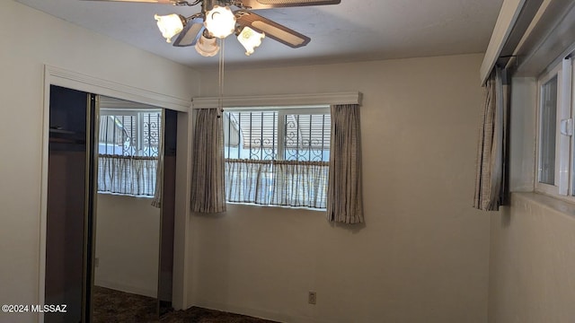 spare room with a wealth of natural light and ceiling fan