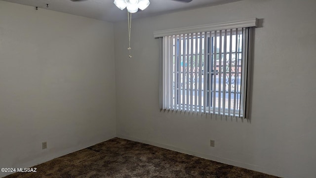 carpeted spare room with ceiling fan