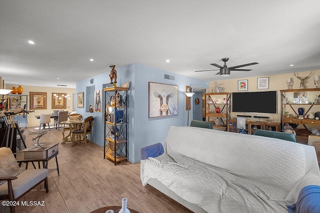 living room with ceiling fan and light wood-type flooring