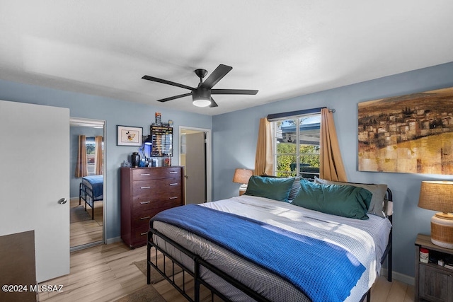 bedroom with ceiling fan and light wood-type flooring