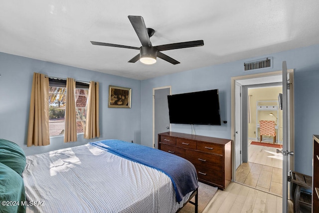 bedroom with ceiling fan and light hardwood / wood-style floors