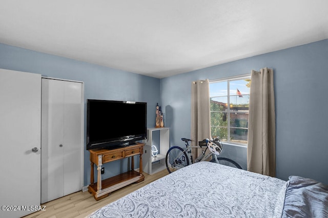 bedroom with a closet and light hardwood / wood-style floors