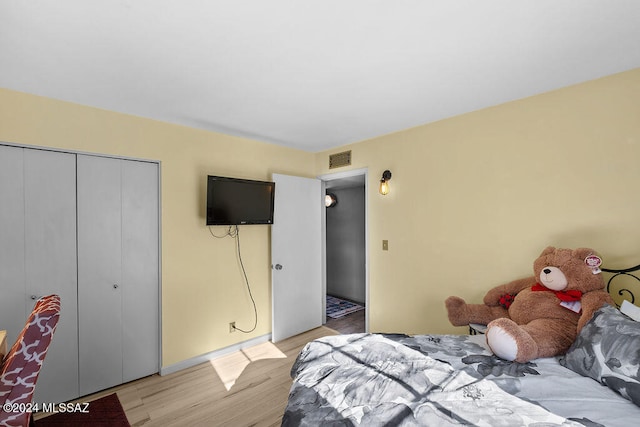 bedroom featuring a closet and light hardwood / wood-style flooring