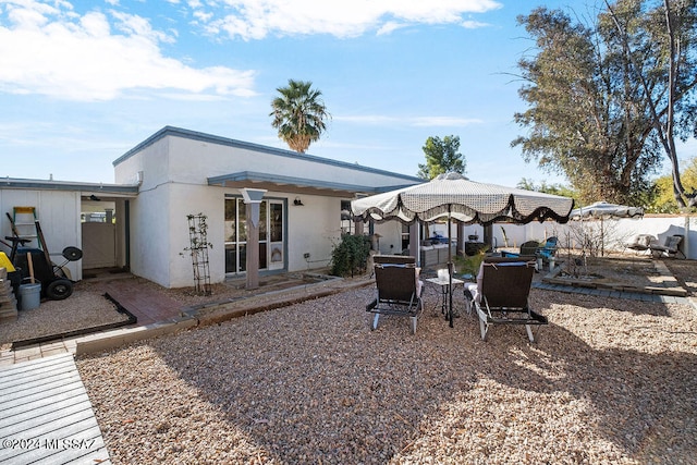 back of house with a patio