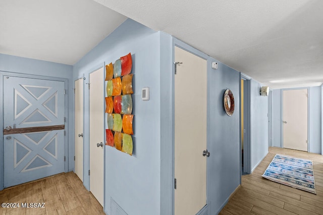 hallway with light hardwood / wood-style floors