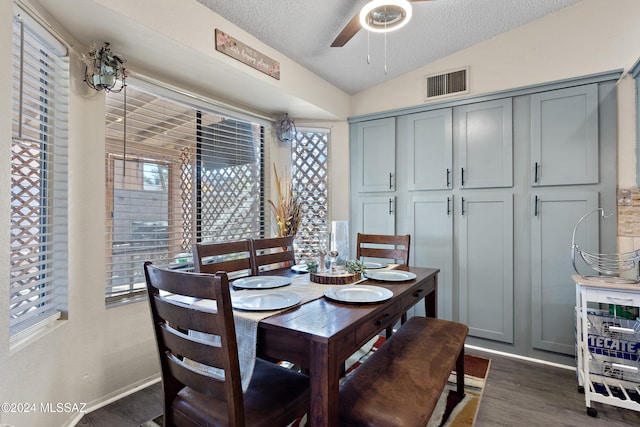 dining room featuring a textured ceiling, dark hardwood / wood-style flooring, ceiling fan, and lofted ceiling