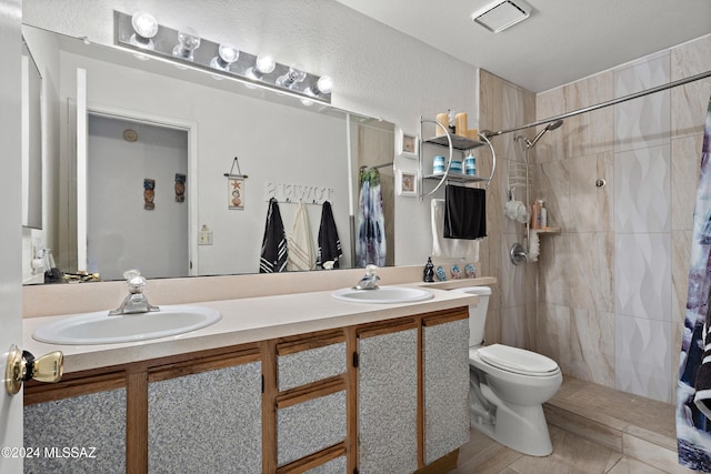 bathroom featuring a shower with curtain, vanity, and toilet