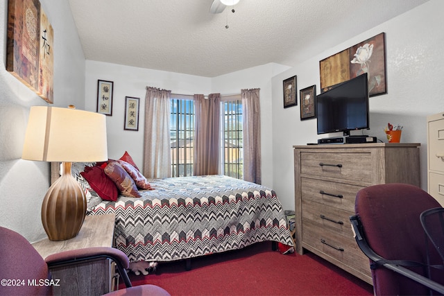 bedroom featuring ceiling fan, carpet, and a textured ceiling