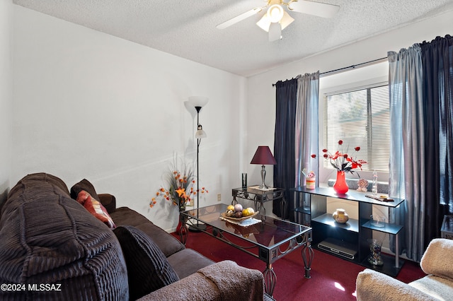 carpeted living room with ceiling fan and a textured ceiling