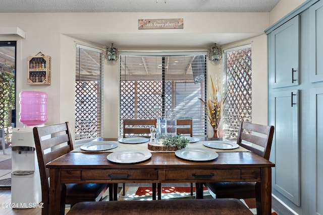 dining space with a textured ceiling