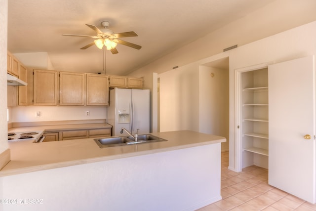 kitchen with kitchen peninsula, light brown cabinetry, white appliances, sink, and light tile patterned flooring