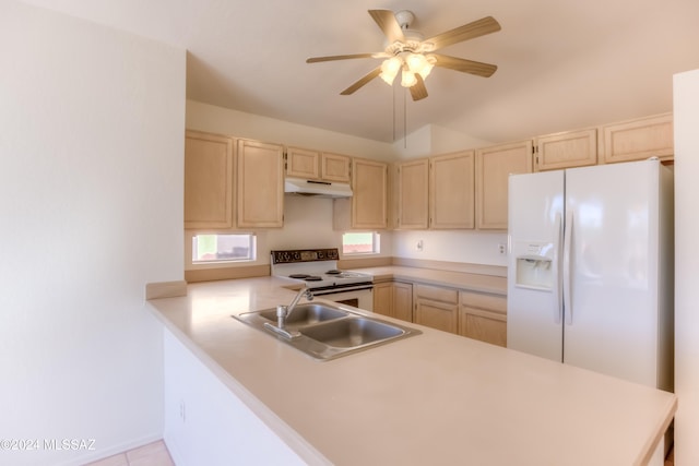 kitchen featuring sink, kitchen peninsula, lofted ceiling, white appliances, and light tile patterned flooring