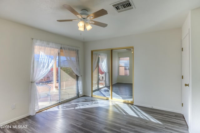 empty room featuring ceiling fan and dark hardwood / wood-style flooring