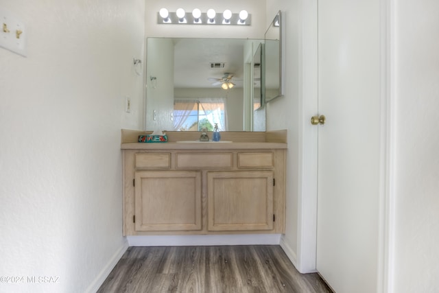 bathroom with vanity, hardwood / wood-style flooring, and ceiling fan