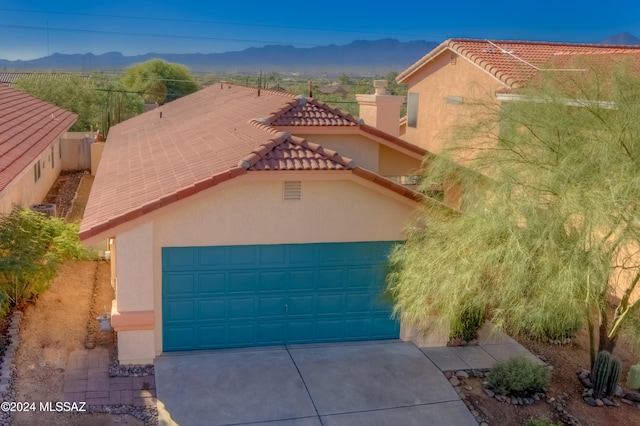 mediterranean / spanish-style house featuring a mountain view and a garage