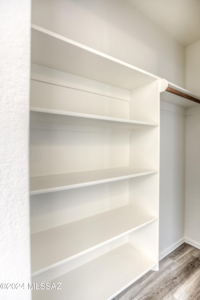 walk in closet featuring hardwood / wood-style flooring