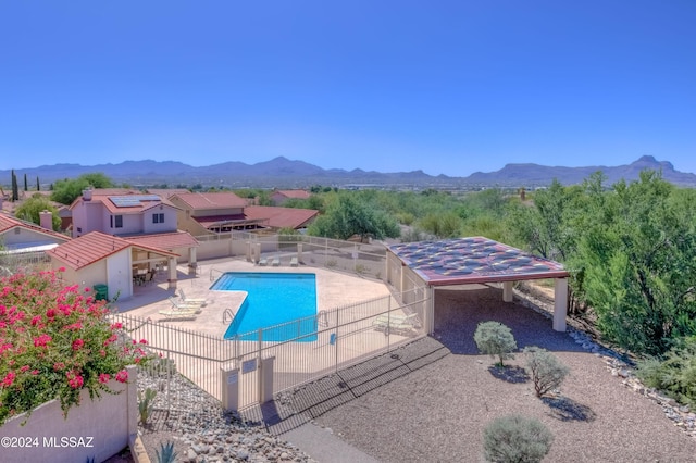 view of pool featuring a mountain view and a patio area