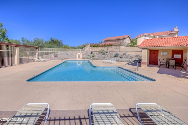 view of swimming pool with a patio