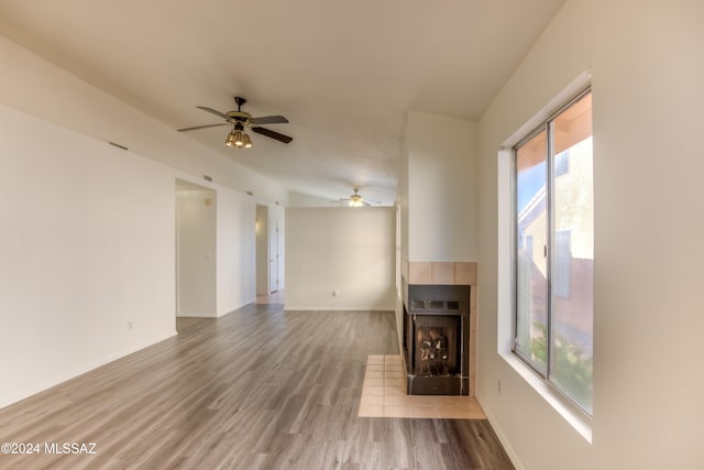 unfurnished living room with ceiling fan, a fireplace, and hardwood / wood-style flooring