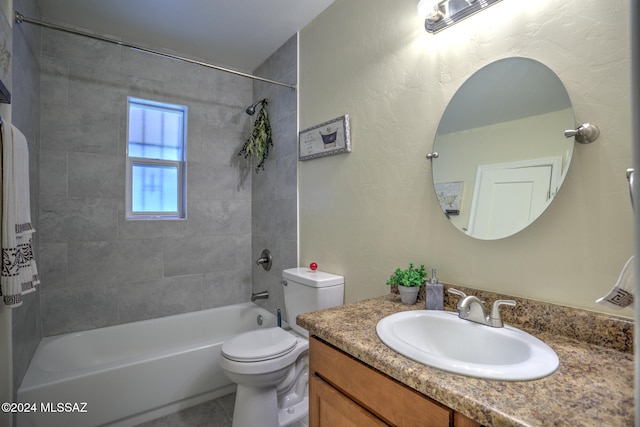 full bathroom featuring vanity, tiled shower / bath combo, and toilet