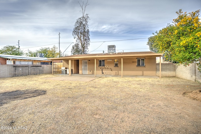 rear view of house featuring cooling unit