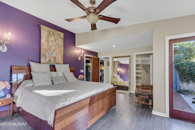 bedroom featuring access to outside, a closet, a spacious closet, and ceiling fan