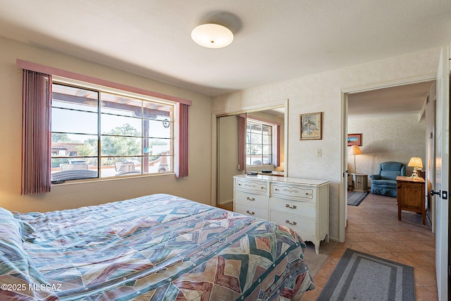 tiled bedroom with a closet