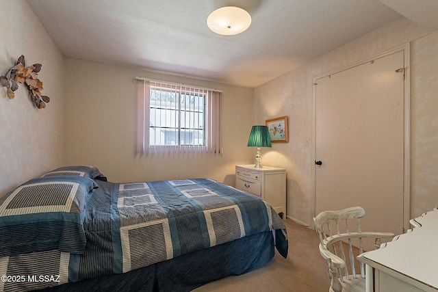 bedroom featuring light colored carpet