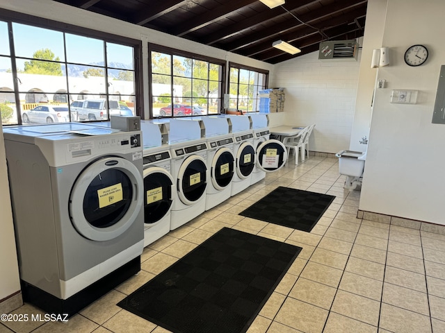 laundry area with wood ceiling, light tile patterned floors, and washing machine and clothes dryer