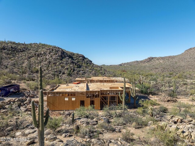 back of house with a mountain view