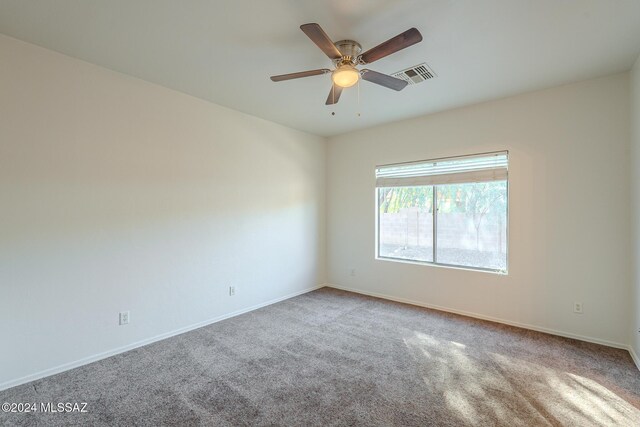 unfurnished bedroom with carpet flooring, a walk in closet, ensuite bathroom, ceiling fan, and a closet