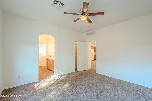 spare room featuring ceiling fan and carpet floors